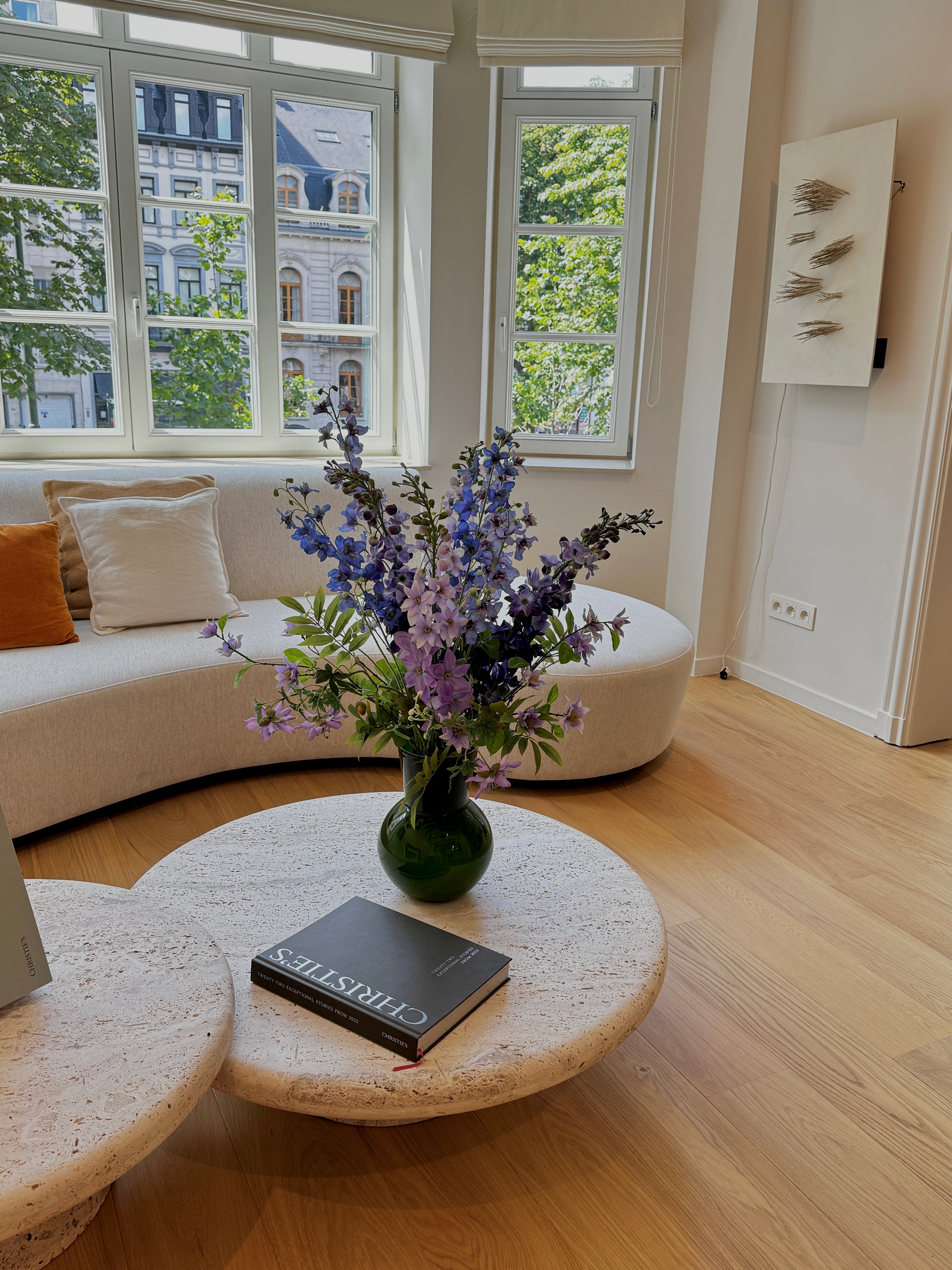 Summer arrangement with silk flowers. Delphiniums.